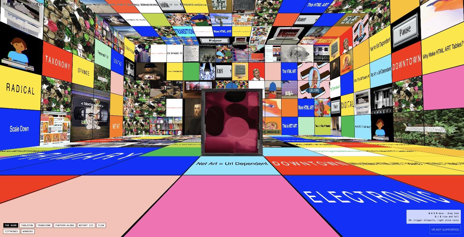 A dark pink glossy velvet box sculpture standing in the centre of a room whose every surface is a collage of HTML artwork